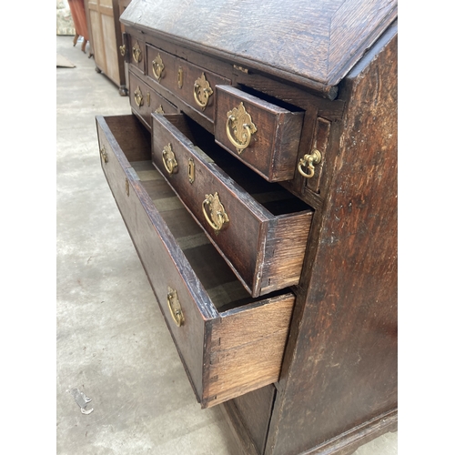 3169 - A GEORGE III OAK BUREAU WITH FITTED INTERIOR AND SEVEN DRAWERS TO BASE ON BRACKET FEET 36