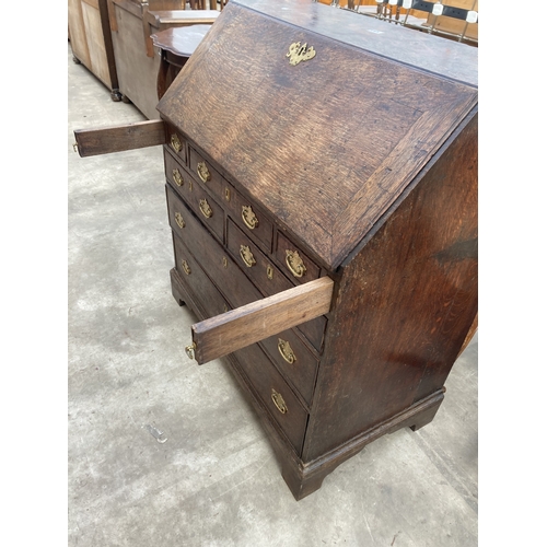 3169 - A GEORGE III OAK BUREAU WITH FITTED INTERIOR AND SEVEN DRAWERS TO BASE ON BRACKET FEET 36