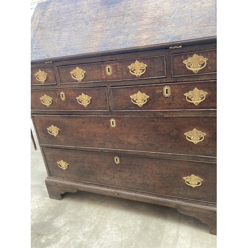 3169 - A GEORGE III OAK BUREAU WITH FITTED INTERIOR AND SEVEN DRAWERS TO BASE ON BRACKET FEET 36