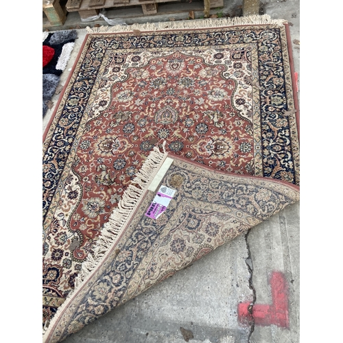 2500 - A RED PATTERNED FRINGED RUG