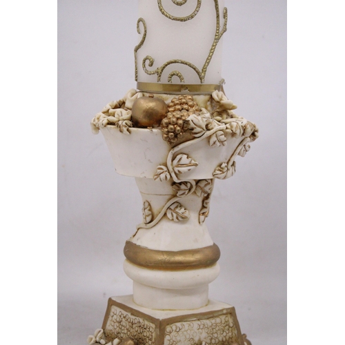 237 - AN ORNATELY DECORATED CANDLE STICK HOLDER WITH FRUIT AND FLOWER DECORATIONS TOGETHER WITH CANDLE, HE... 