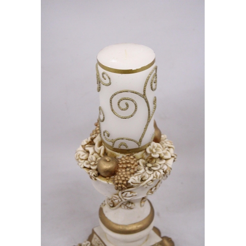 237 - AN ORNATELY DECORATED CANDLE STICK HOLDER WITH FRUIT AND FLOWER DECORATIONS TOGETHER WITH CANDLE, HE... 