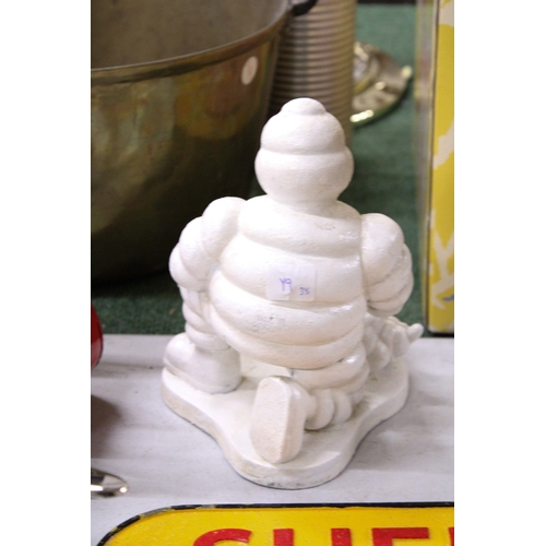 291A - A CAST MICHELIN MAN AND DOG, HEIGHT 20CM