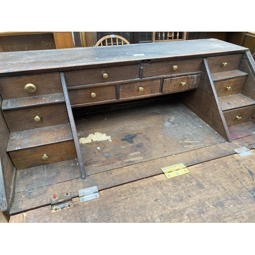 2973 - AN OAK GEORGE III BUREAU WITH FITTED INTERIOR AND THREE DRAWERS TO BASE, 37