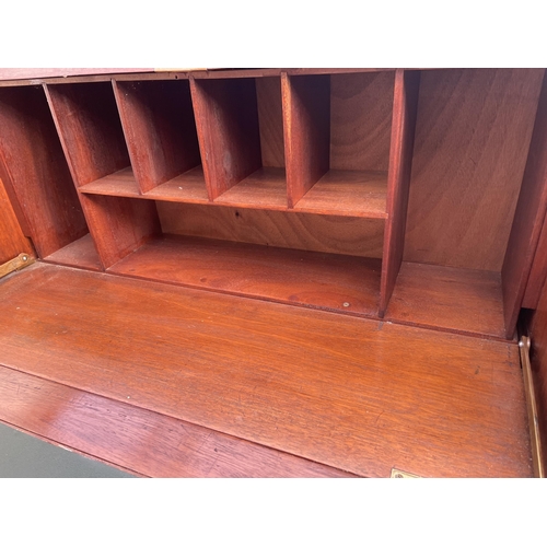 3021 - A MAHOGANY BUREAU WITH THREE DRAWERS HAVING PORCELAIN KNOBS, 36