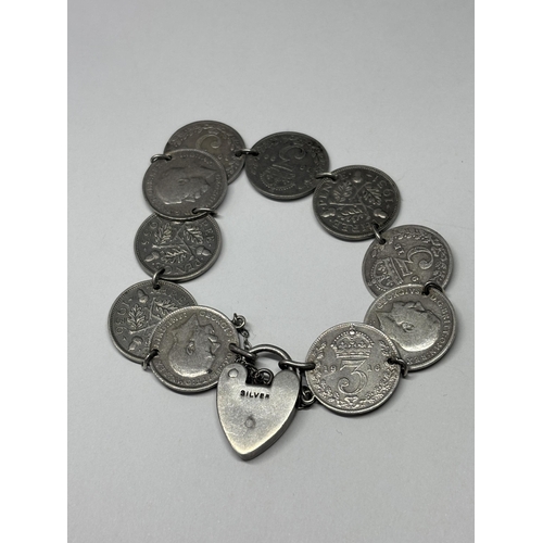  A SILVER BRACELET WITH TEN SILVER JOEYS AND A HEAT PADLOCK