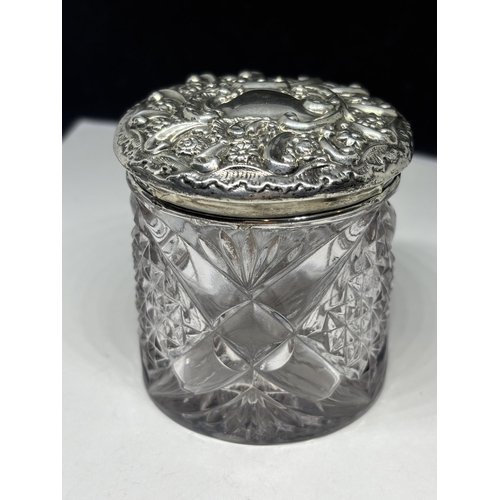  A CUT GLASS POT WITH A DECORATIVE HALLMARKED BIRMINGHAM SILVER LID