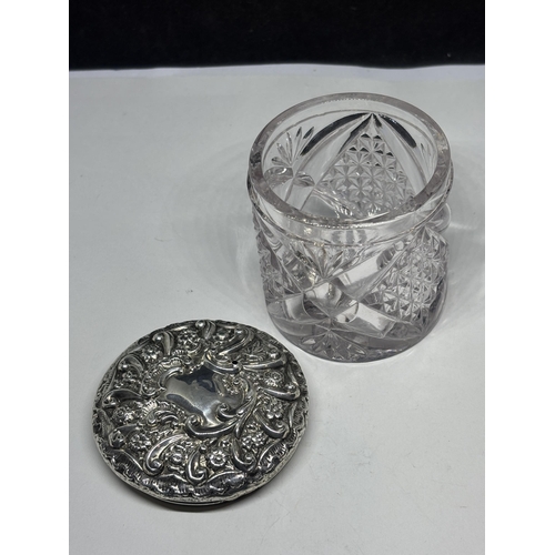  A CUT GLASS POT WITH A DECORATIVE HALLMARKED BIRMINGHAM SILVER LID