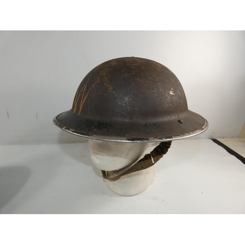 334 - A WORLD WAR II BRITISH PAINTED METAL HELMET AND LINER