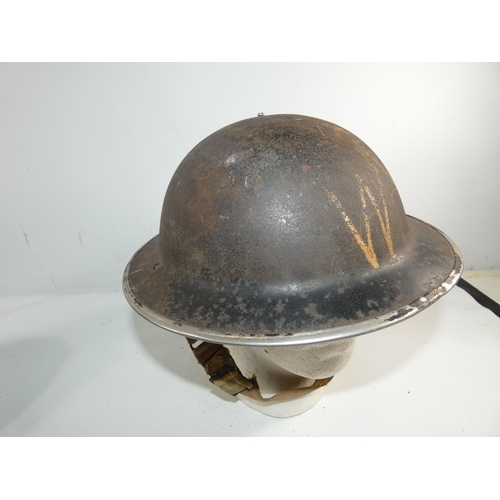 334 - A WORLD WAR II BRITISH PAINTED METAL HELMET AND LINER