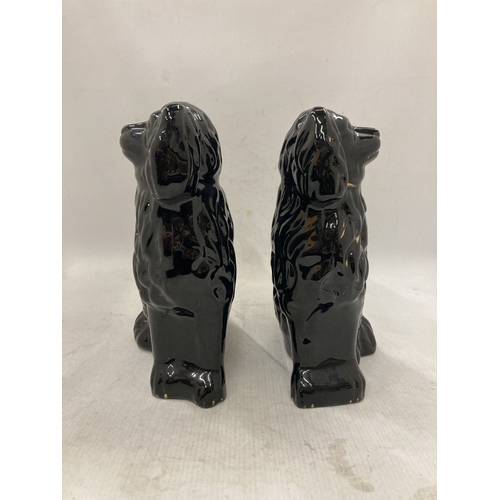 101 - A PAIR OF BLACK STAFFORDSHIRE JACKFIELD STYLE SPANIEL FIGURES - 24.5 CM