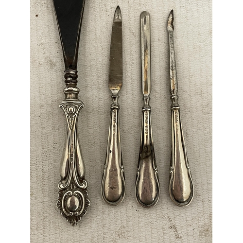 10 - FIVE HALLMARKED SILVER ITEMS TO INCLUDE THREE MANICURE ITEMS AND A SHOE HORN WITH SILVER HANDLES AND... 