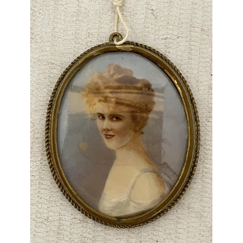 11 - A VINTAGE HAND PAINTED MINIATURE PORTRAIT IN A YELLOW METAL FRAME