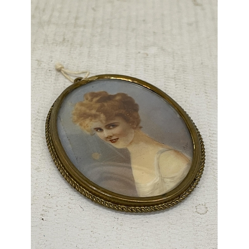 11 - A VINTAGE HAND PAINTED MINIATURE PORTRAIT IN A YELLOW METAL FRAME