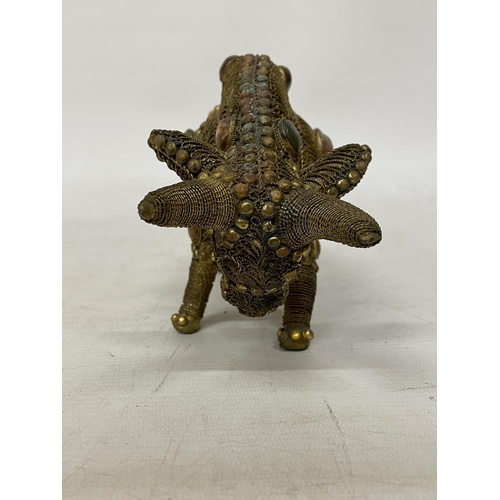 14 - A TIBETAN BRASS FILIGREE MODEL OF A BULL WITH INLAID SEMI PRECIOUS STONES, HEIGHT 13CM, LENGTH 21CM