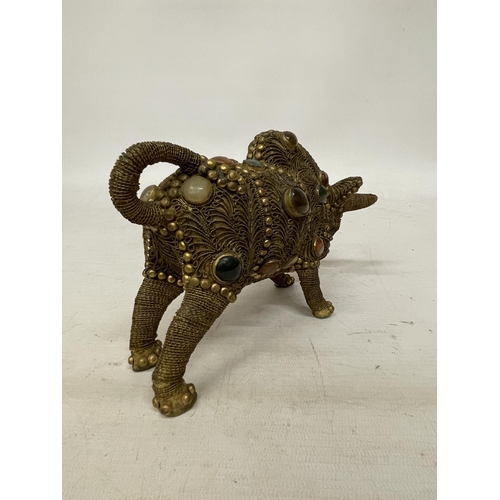 14 - A TIBETAN BRASS FILIGREE MODEL OF A BULL WITH INLAID SEMI PRECIOUS STONES, HEIGHT 13CM, LENGTH 21CM