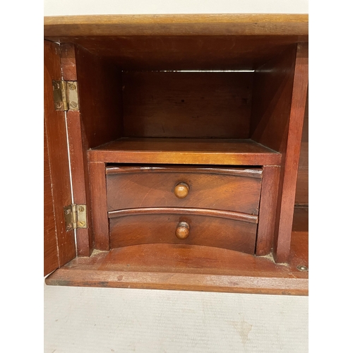 17 - AN EARLY 20TH CENTURY MAHOGANY SMOKERS CABINET WITH TWO DRAWERS AND GLAZED PANELS TO THE FRONT, HEIG... 