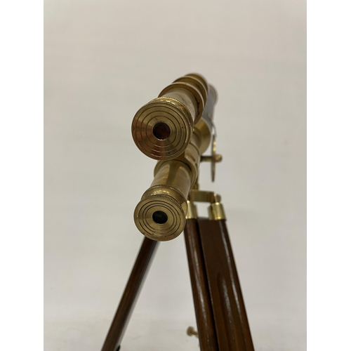 18 - A WOOD AND BRASS TELESCOPE WITH SIGHTS AND TRIPOD LEGS