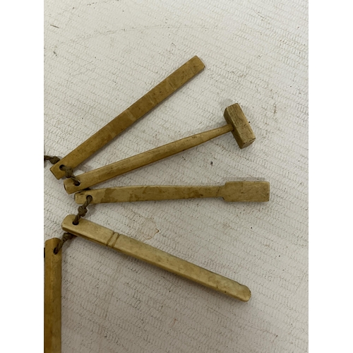 23 - A GROUP OF 19TH CENTURY CARVED BONE INSTRUMENTS TO INCLUDE A HAMMER, CRICKET BAT, ETC, APPROX 9CM LO... 