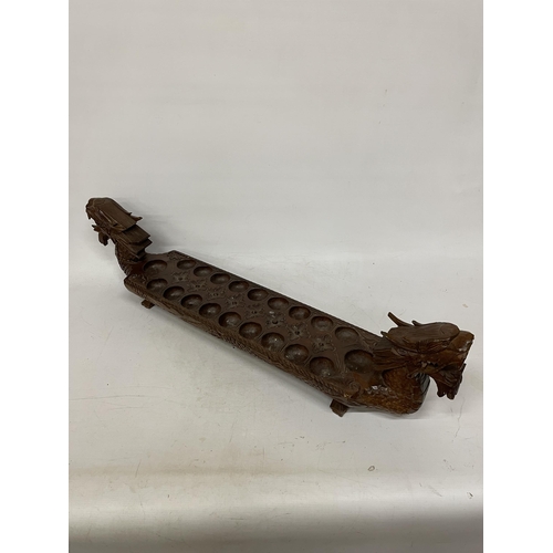 26 - A VINTAGE HARDWOOD ORIENTAL DRAGON SHAPED 'MONCALA' COUNT AND CATCH GAME (NO COUNTERS) - LENGTH 89CM