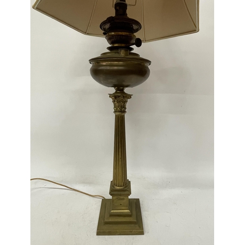 43 - A LARGE BRASS OIL LAMP WITH CORINTHIAN COLUMN, CONVERTED TO ELECTRIC, WITH SHADE, HEIGHT APPROX 64CM