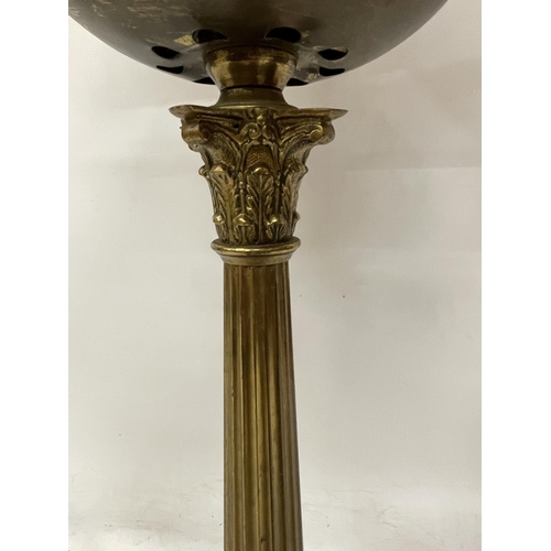 43 - A LARGE BRASS OIL LAMP WITH CORINTHIAN COLUMN, CONVERTED TO ELECTRIC, WITH SHADE, HEIGHT APPROX 64CM