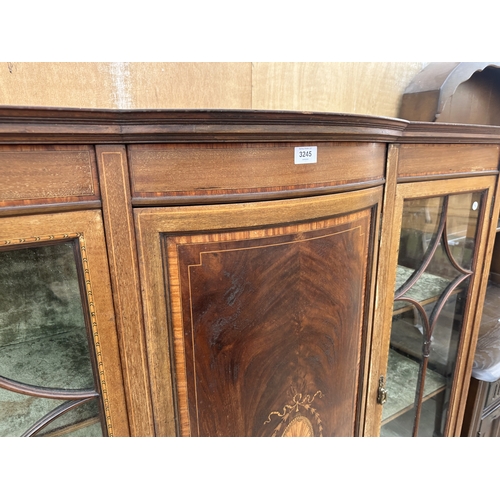 3245 - AN EDWARDIAN MAHOGANY AND INLAID SHERATON REVIVAL BOW FRONTED CHINA CABINET ON OPEN BASE WITH TAPERI... 