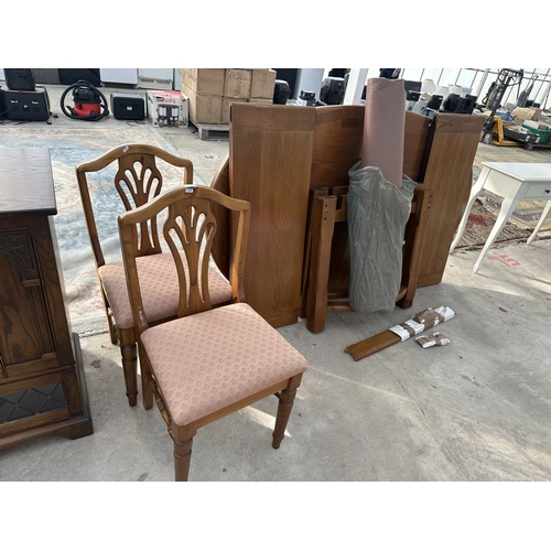 3247 - AN OAK EXTENDING DIDNING TABLE WITH TWO LEAVES AND TWO DINING CHAIRS