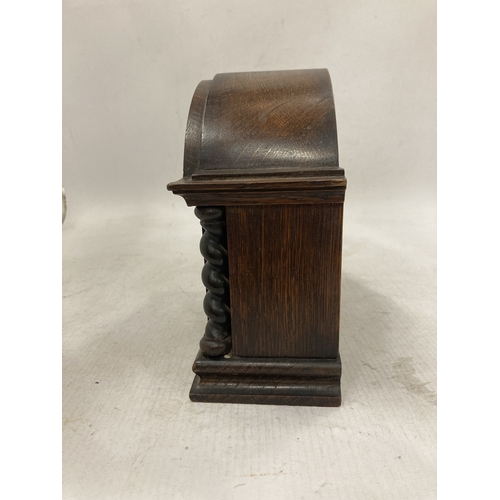 105 - A RARE ANTIQUE FRENCH EIGHT DAY MANTLE CLOCK IN A SOLID WOOD CASE WITH BARLEY TWIST COLUMNS CIRCA 19... 