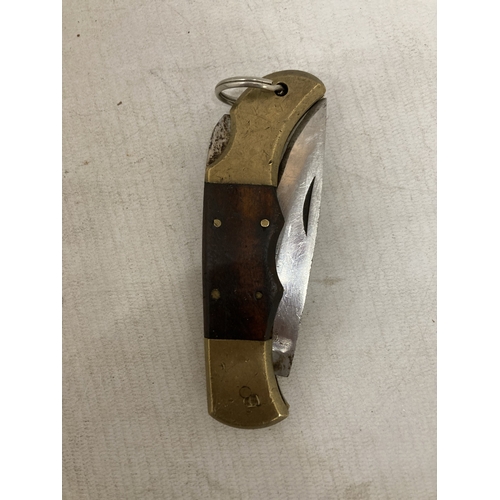 221 - A HEAVY BRASS AND WOOD KNIFE FROM PAKISTAN