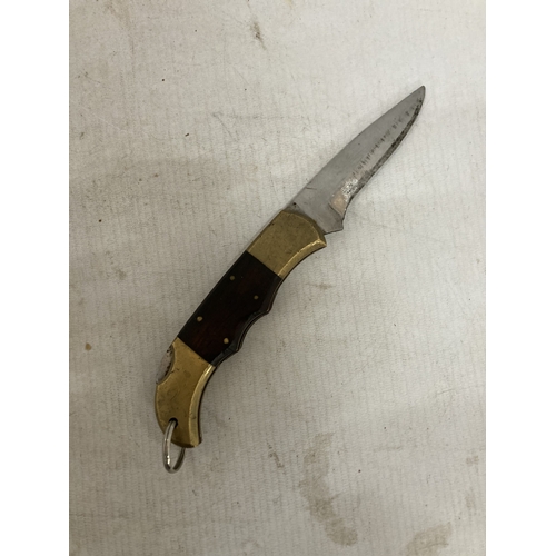 221 - A HEAVY BRASS AND WOOD KNIFE FROM PAKISTAN