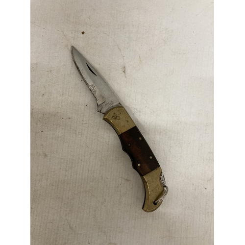 221 - A HEAVY BRASS AND WOOD KNIFE FROM PAKISTAN