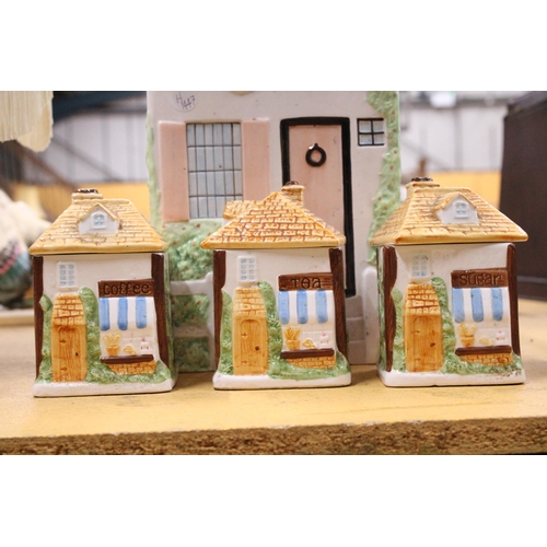 409 - A CERAMIC COTTAGE STYLE BREAD BIN WITH TEA, COFFEE AND SUGAR