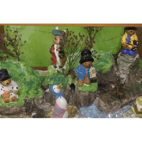 413 - A PLASTERCASTERS DISPLAY TO INCLUDE PADDINGTON BEAR AND BEATRIX POTTER FIGURES IN A LARGE GLASS DISP... 