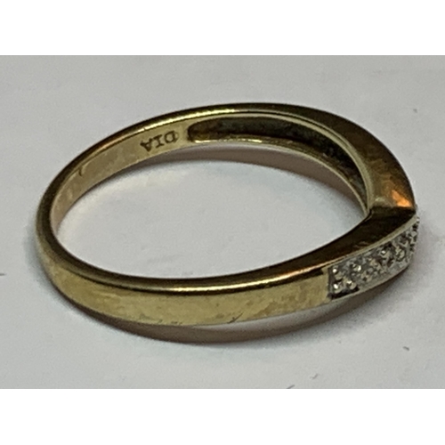 603 - A MARKED 9 CARAT GOLD WISHBONE RING WITH DIAMONDS SIZE N