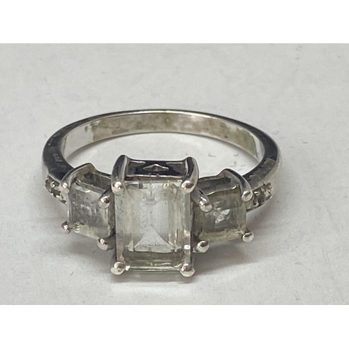 689A - A SILVER DRESS RING WITH THREE IN LINE RECTANGULAR CLEAR STONES SIZE N/O IN A PRESENTATION BOX