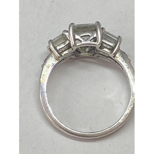 689A - A SILVER DRESS RING WITH THREE IN LINE RECTANGULAR CLEAR STONES SIZE N/O IN A PRESENTATION BOX