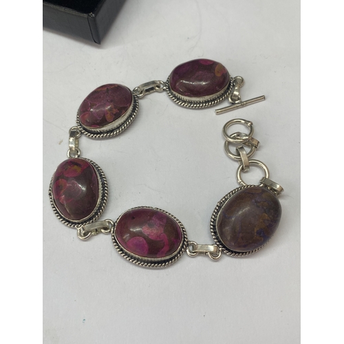 691A - A MARKED 925 BRACELET WITH PURPLE AND RED STONES IN A PRESENTATION BOX