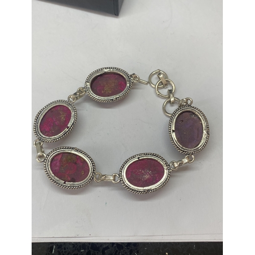 691A - A MARKED 925 BRACELET WITH PURPLE AND RED STONES IN A PRESENTATION BOX