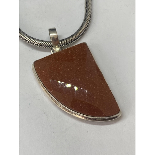 695A - A MARKED 925 HEAVY NECKLACE WITH A  LARGE GOLDSTONE PENDANT IN A PRESENTATION BAG