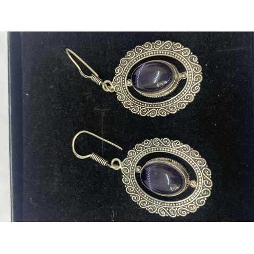 698A - A PAIR OF MARKED 925 EARRINGS WITH PURPLE STONES IN A PRESENTATION BOX