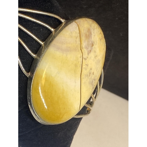 700 - A MARKED 925 BANGLE WITH LARGE JASPER STONE ( NOT CRACKED, IS A NATURAL INCLUSION)