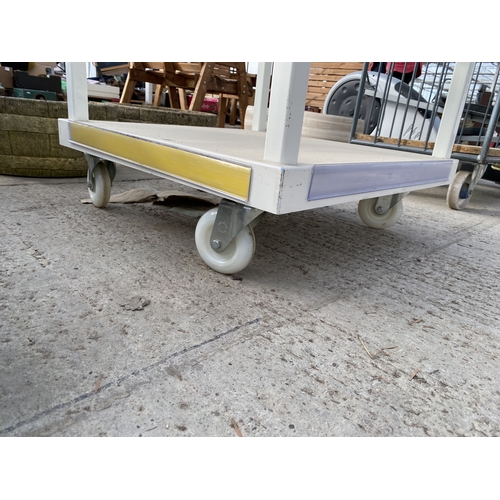 1987 - A METAL AND GLASS SIX TIER RETAIL DISPLAY STAND WITH FOUR WHEELED BASE