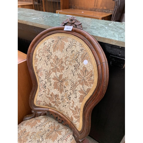 2615 - A VICTORIAN ROSEWOOD BOUDOIR CHAIR WITH FOLIATE BACK RAIL AND CABRIOLE FRONT LEGS