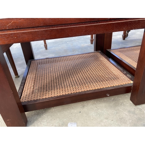 2800 - A PAIR OF LAMP TABLES WITH GLASS TOPS AND CANE UNDER SHELF, 25.5