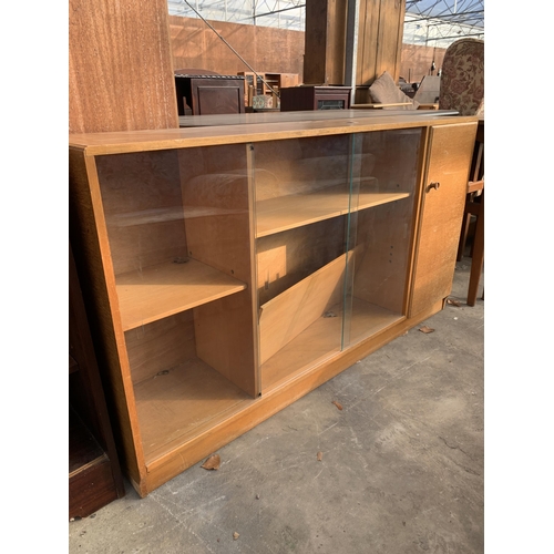 2871 - A MID 20TH CENTURY OAK CASTLE FURNITURE BOOKCASE ENCLOSING CUPBOARDS AND THREE GLASS SLIDING DOORS, ... 