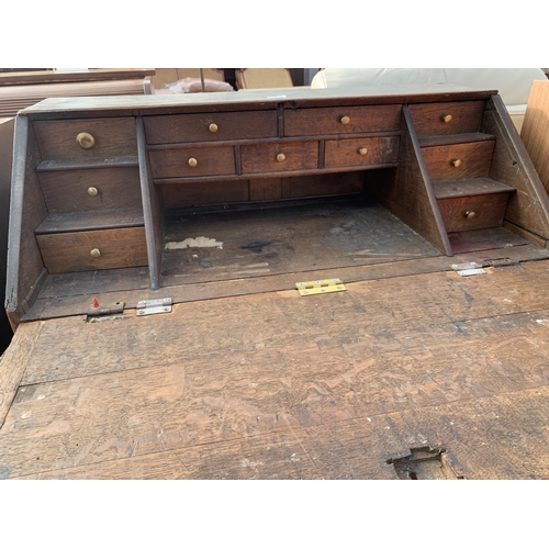 2890 - AN OAK GEORGE III BUREAU WITH FITTED INTERIOR AND THREE DRAWERS TO BASE, 37