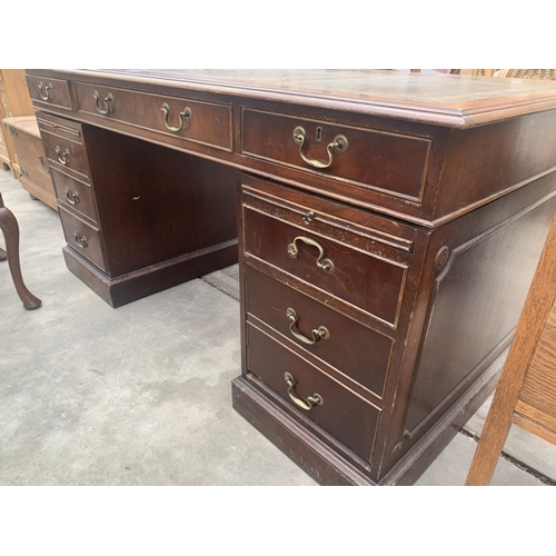 3031 - A MAHOGANY TWIN PEDESTAL DESK ENCLOSING TEN DRAWERS, TWO BEING SHAM AND SLIDE WITH INSET LEATHER TOP