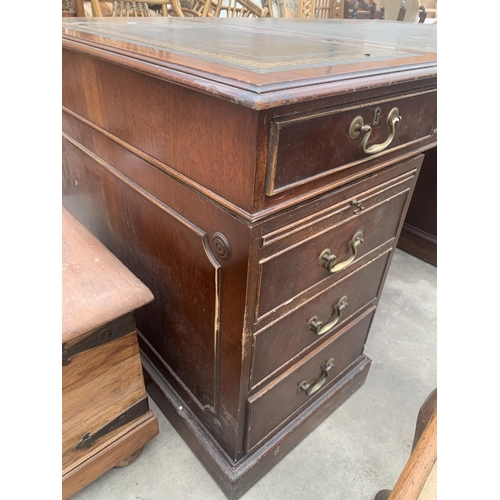 3031 - A MAHOGANY TWIN PEDESTAL DESK ENCLOSING TEN DRAWERS, TWO BEING SHAM AND SLIDE WITH INSET LEATHER TOP