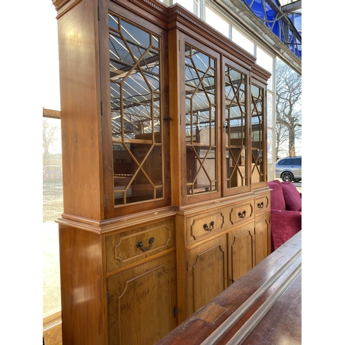 3071 - A YEW WOOD BREAKFRONT FOUR DOOR ASTRAGAL GLAZED BOOKCASE WITH DENTIL CORNICE, FOUR DRAWERS AND FOUR ... 